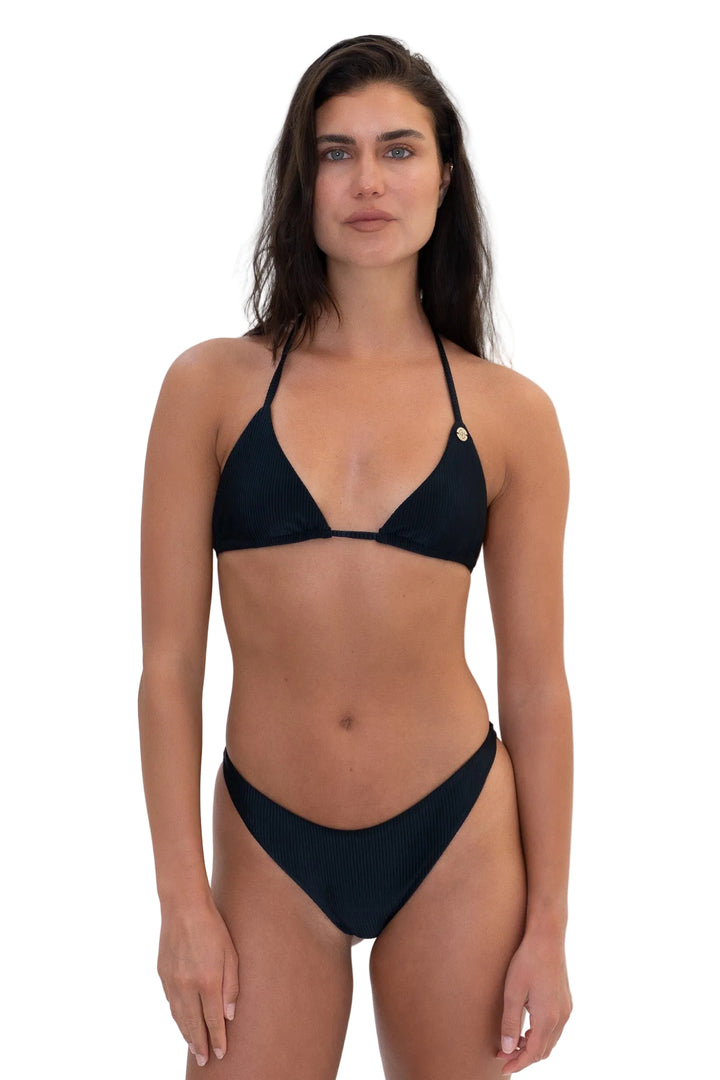 Model wearing the KALLINA black ribbed triangle bikini top paired with matching black MAIU bikini bottoms by Almaya Swimwear.